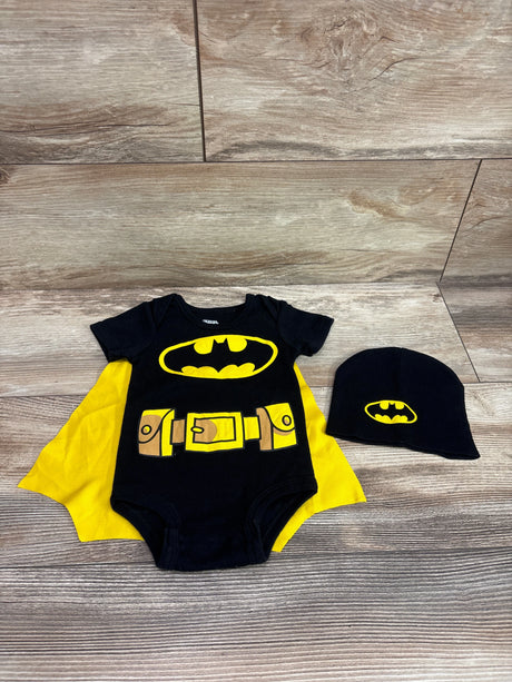 Front view of Justice League Batman 2pc caped bodysuit and hat set with yellow logos and utility belt on wood background