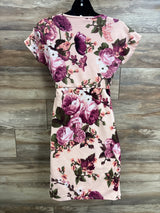 Back view of Pinkblush rose floral fitted wrap maternity dress in pink showing fitted waist and cap sleeves on wood plank background