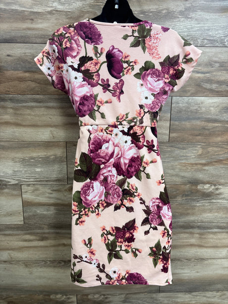 Back view of Pinkblush rose floral fitted wrap maternity dress in pink showing fitted waist and cap sleeves on wood plank background