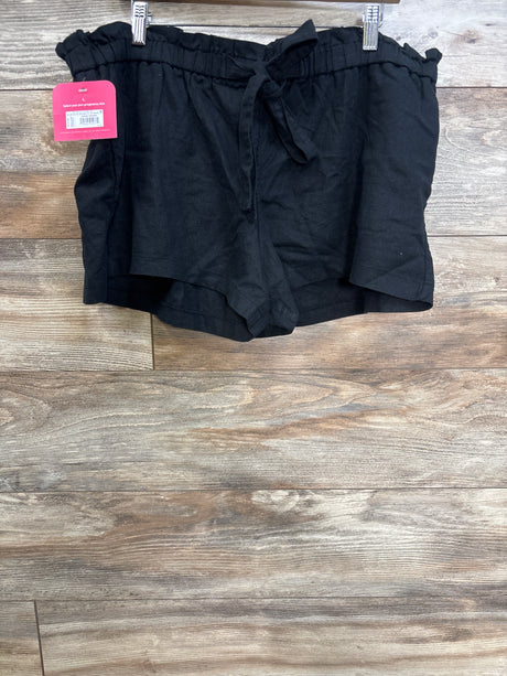 Front view of black maternity tie-front pull-on shorts showing paperbag elastic waistband and tied bow on wood background