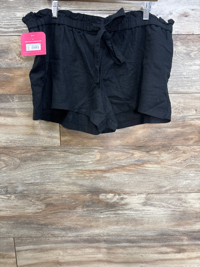 Front view of black maternity tie-front pull-on shorts showing paperbag elastic waistband and tied bow on wood background