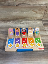 Front view of Melissa and Doug My Daily Day and Night wooden routines chart with five animal tabs, check marks, and stars