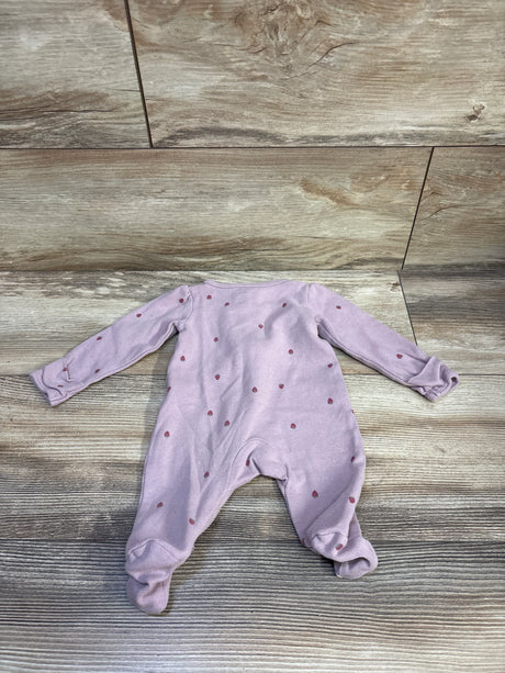 Back view of Carter’s newborn footed sleeper showcasing light purple fabric with small strawberry print on wood background