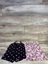 Front view of two Children's Place tank rompers (size 4T) showing black floral romper and pink tropical-leopard romper on wood floor