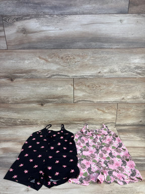Front view of two Children's Place tank rompers (size 4T) showing black floral romper and pink tropical-leopard romper on wood floor