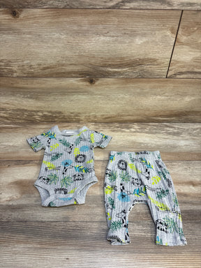 Gray ribbed baby bodysuit and pants set with jungle animal print, laid on wood floor