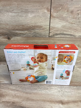 Front of boxed Fisher-Price tambourine and maracas showing baby and headline Baby's got rhythm on wood floor background