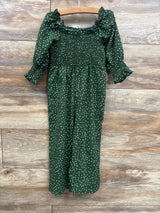Green polka dot maternity dress with smocked bodice and ruffled sleeves, perfect for pregnancy fashion.