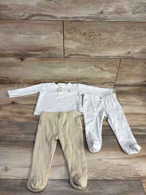 Infant long sleeve white shirt with beige and white footed pants on wood background