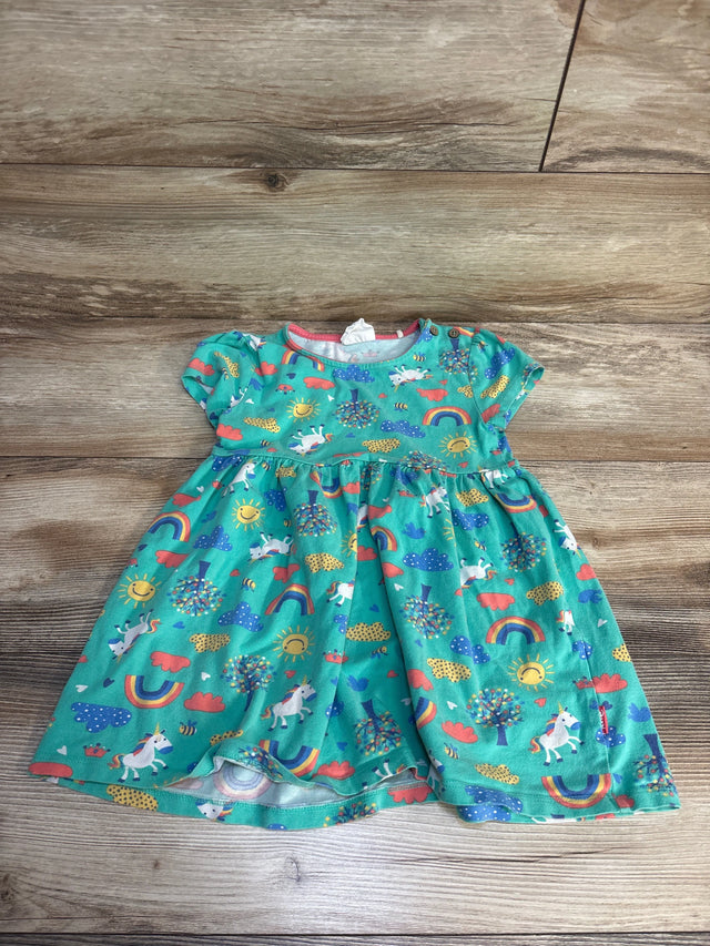 Teal baby dress with unicorn, rainbow, and sun print on wood floor