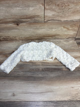 White textured baby bolero jacket with long sleeves on wooden background