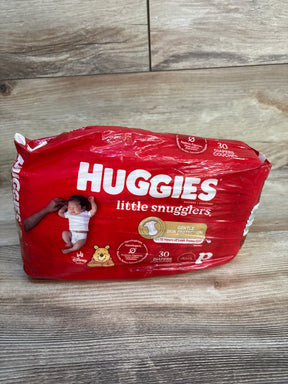 Front view of Huggies Little Snugglers preemie 30-count pack showing Gentle Skin Protection label and Winnie the Pooh graphic on wood floor