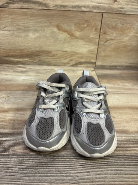 Front view of Nike V5 RNR TD Cave Stone sneakers showcasing gray mesh uppers, laces, and white soles on a wood floor