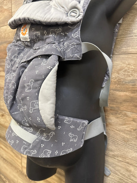 Front view of Ergobaby All Positions 360 Carrier in Trunks Up showcasing gray elephant print and padded straps with a wood floor background