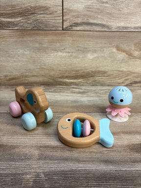 Wooden toy car, fish rattle, and octopus figure on wooden surface, baby toys resale