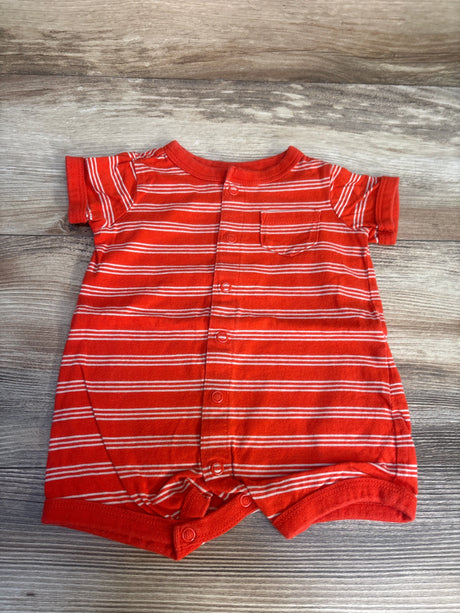 Red and white striped baby romper with short sleeves and front buttons on wood background