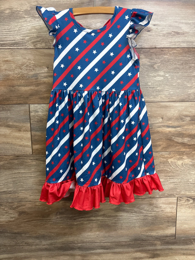Front view of Pete & Lucy girls' Stars & Stripes dress size 5T showing diagonal red and white star print and red ruffle hem on wood background