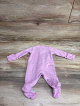 Front view of a pink Just One You waffle-knit footed sleeper in newborn size with long sleeves on a wood-look floor