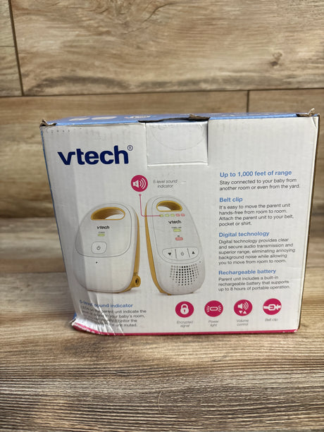 Back view of VTech DM111 digital audio baby monitor box showcasing white packaging with product features and feature icons on wood plank floor
