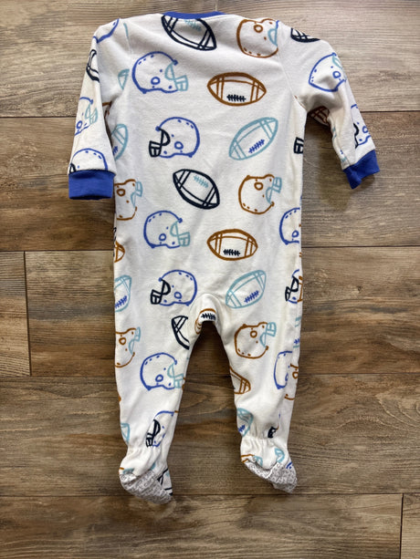 Front view of Carter’s football blanket sleeper showcasing white fabric with football and helmet print on a wood floor