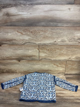Blue floral long sleeve baby shirt with navy trim on wood background