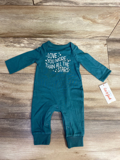 Teal long sleeve baby romper with snap buttons and white text reading Love You More Than All The Stars on wood floor