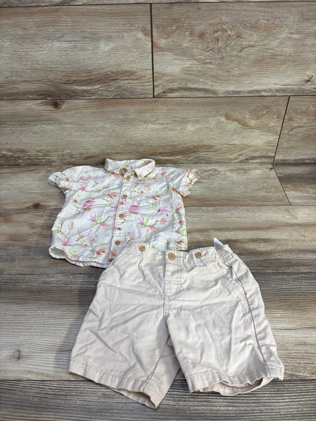 Top-down view of H&M button-up shirt and shorts set showcasing floral-print short-sleeve shirt and ivory shorts on wood floor