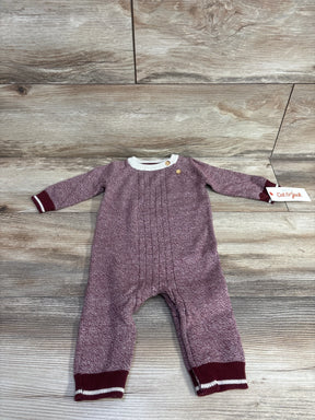 Maroon knit baby romper with white trim and buttons, Cat & Jack label, on wood floor