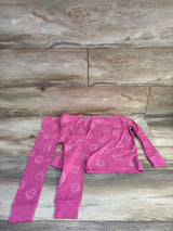 Flat lay toddler 2-piece pink Gabby's Dollhouse pajama set 3T with long-sleeve top and pants on wood background