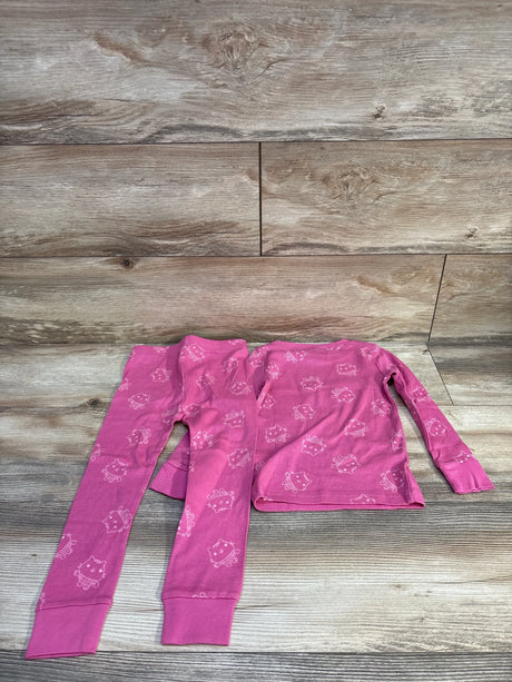 Flat lay toddler 2-piece pink Gabby's Dollhouse pajama set 3T with long-sleeve top and pants on wood background