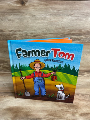 Children's book Farmer Tom cover featuring cartoon farmer with carrots and dog on a farm