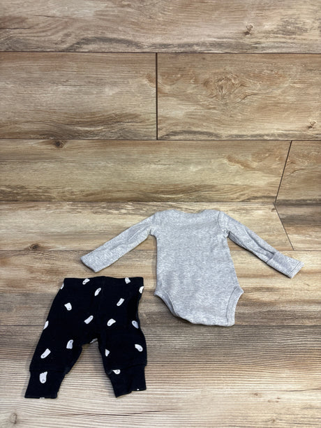 Flat lay of newborn heather grey long-sleeve bodysuit and black pants with white ghost print on wood plank background
