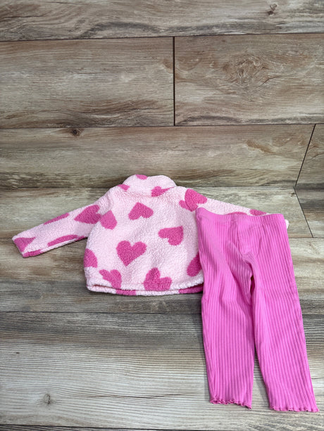 Flat lay of pink Just One You sherpa sweatshirt and pants set with heart pattern and ribbed pants on wood