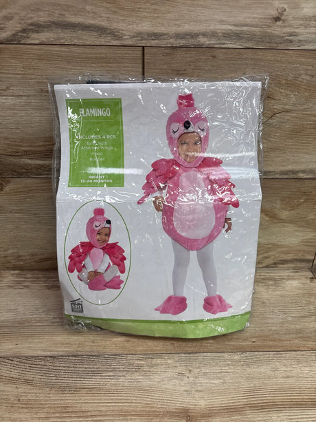 Front view of pink flamingo costume package showing hood, attached wings, and booties on a wood background