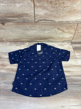 Back view of American Hawk navy short sleeve button-up shirt with small white diamond print and size 24M tag on wood
