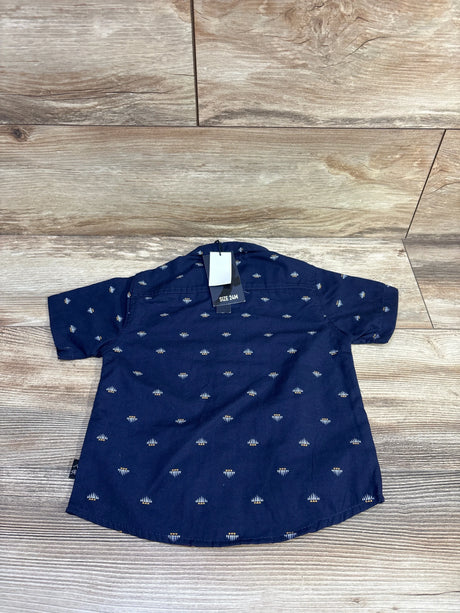 Back view of American Hawk navy short sleeve button-up shirt with small white diamond print and size 24M tag on wood