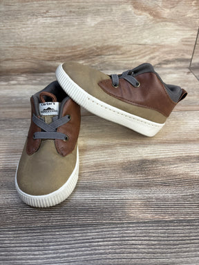 Brown and tan Carter's toddler shoes with gray laces on wood background
