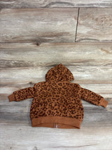 Back view of brown toddler hoodie with dark leopard print pattern on wooden floor