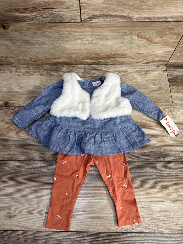 Baby girl's outfit with blue dress and white faux fur vest, paired with rust-colored leggings on wooden floor