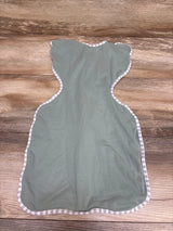 Flat lay of Love To Dream Swaddle Up Lite swaddle in green, size small/newborn, showcasing striped trim on a wood background