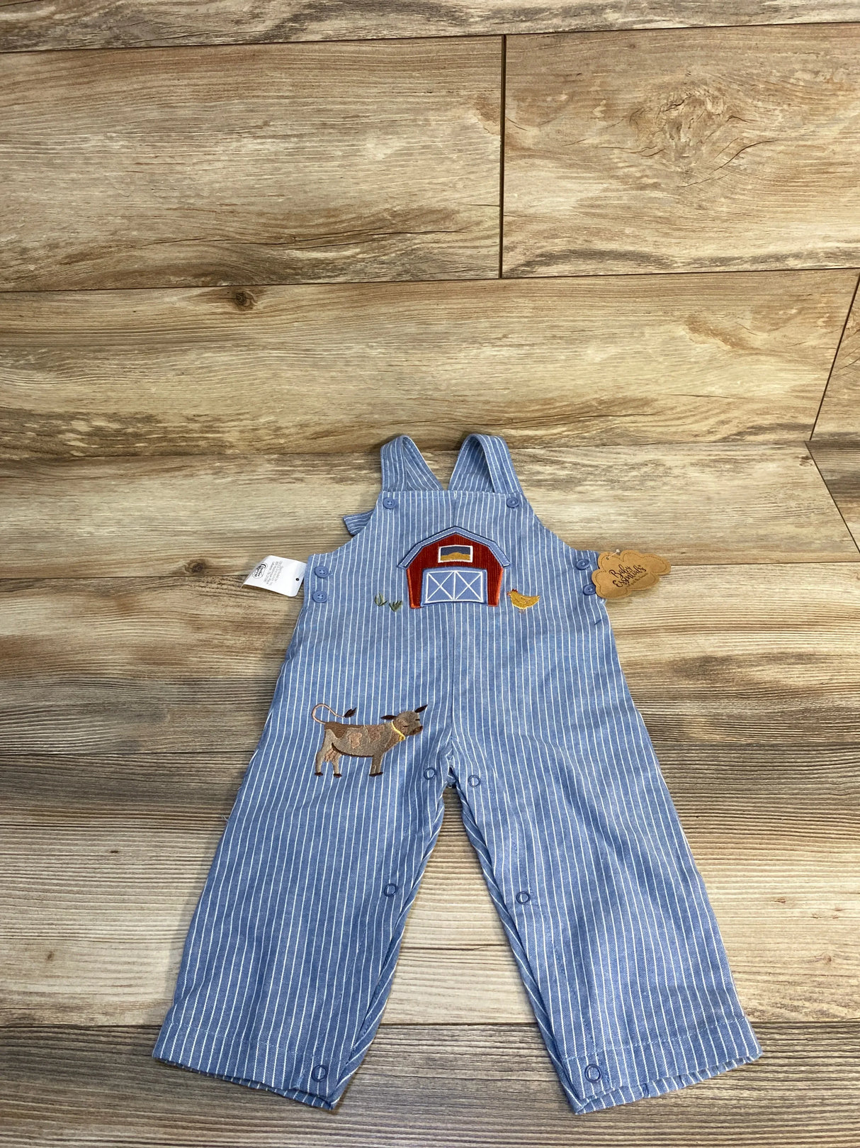 Blue striped baby overalls with barn and cow applique, farmhouse theme, wood background