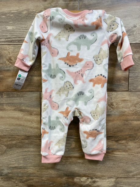Front view of Carter’s blanket sleeper in white with pastel dinosaur print and pink cuffs on a wood floor