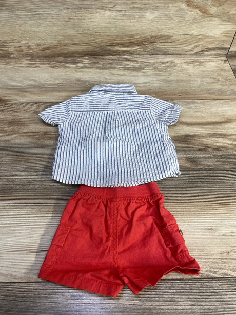 Flat lay of newborn Just One You 2-piece: white striped button-up shirt and red elastic-waist shorts with pockets on wood background