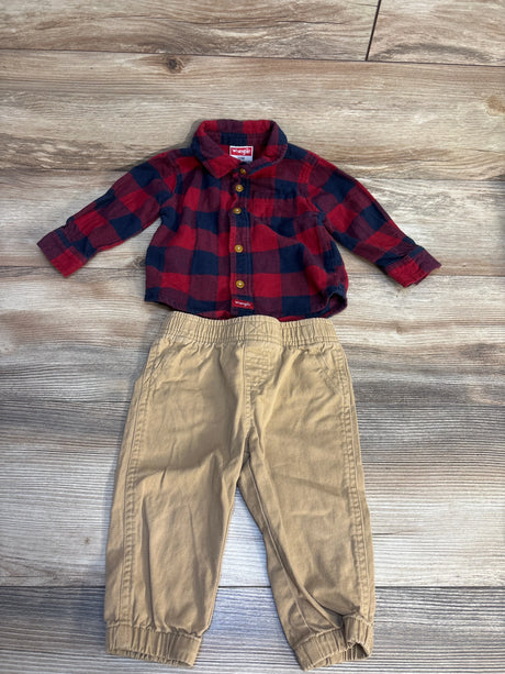 Toddler outfit with red plaid flannel shirt and beige elastic waist pants on wood floor