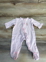 Pink baby onesie with floral embroidery and ruffled details on wooden floor