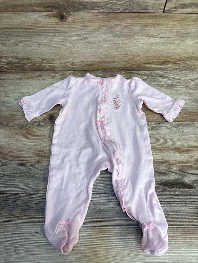 Pink baby onesie with floral embroidery and ruffled details on wooden floor