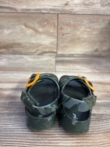 Rear view of Cat and Jack Ade camo footbed sandals showing adjustable heel Velcro straps and orange buckles on wood floor