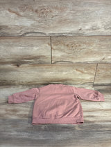 Back view of H&M toddler pullover sweatshirt in pink showing long sleeves and ribbed cuffs and hem on a light wood background