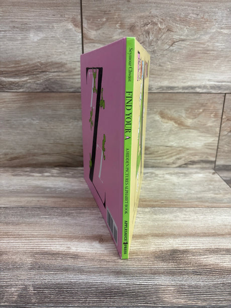 Angled view of Find Your A alphabet search hardcover book showing pink cover, green spine, and tree illustration