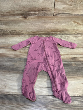 Flat lay of purple footed baby sleeper (9 months) showing front zipper and all-over bow print on wood floor